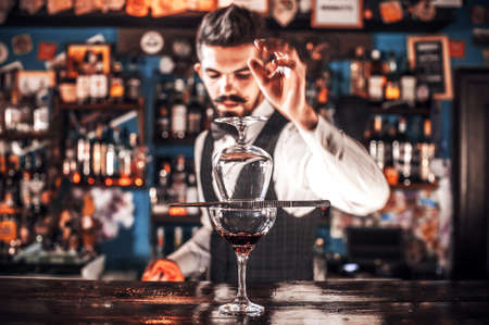 Charismatic Female bartender is pouring a drink in the nightclubの写真素材