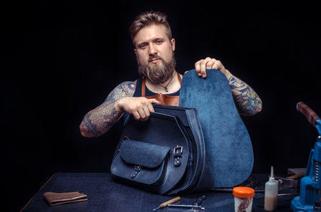 Leather handbag craftsman at work in a workshopの写真素材