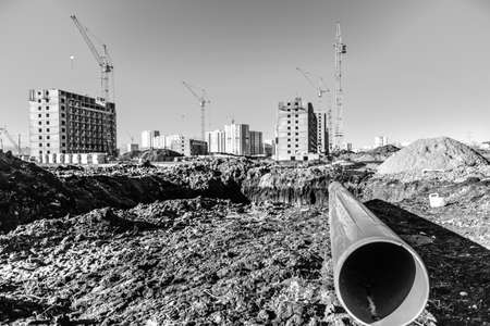 close-up plastic pipe on black land on construction siteの写真素材