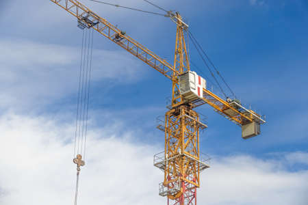 Multistorey housing under construction and construction cranesの写真素材
