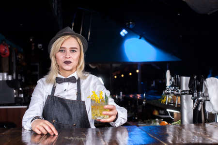 Girl bartender creates a cocktail in the alehouseの写真素材