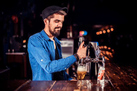 Professional tapster makes a show creating a cocktail at barの写真素材