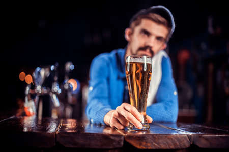 Bartender mixes a cocktail on the alehouseの写真素材