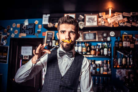 Bartender makes a cocktail on the porterhouseの写真素材