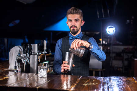 Bartender makes a cocktail on the saloon
