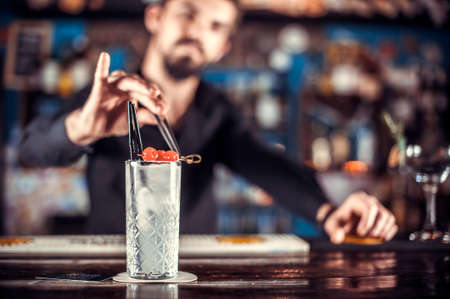 Bartender mixes a cocktail in the brasserieの写真素材