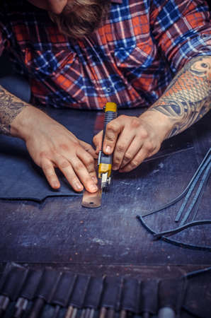 Artisan cutting out leather goodsの写真素材
