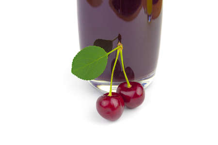 Glass of cherry juice isolated on whiteの写真素材