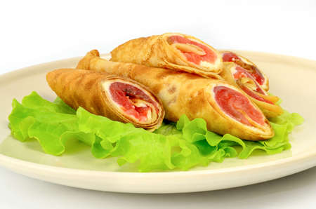 Pancakes with red fish on a piece of lettuceの写真素材