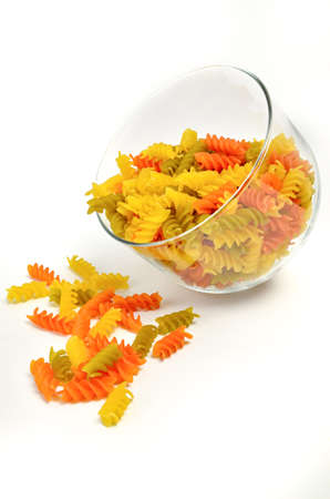 Multicolored rotini pasta on a white backgroundの写真素材
