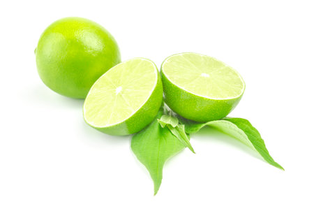 Fresh lime with two half and leaves isolated on white backgroundの写真素材