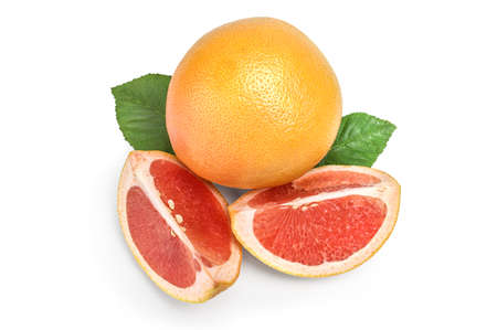 Whole grapefruit and two wedges on white with green leafの写真素材