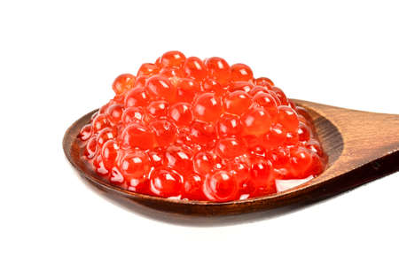 Red caviar in a wooden spoon close on white backgroundの写真素材