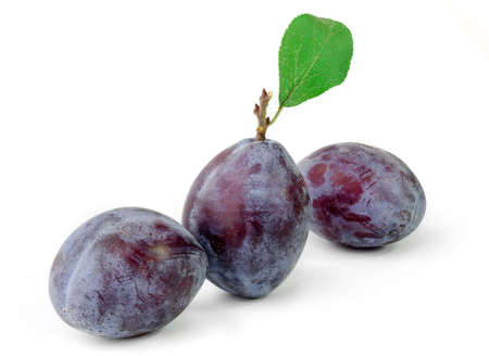 Group of plums with leaf isolated on a white backgroundの写真素材