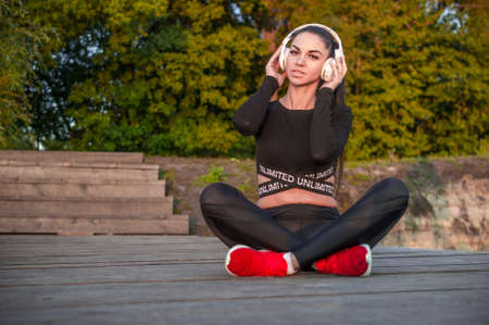 Emotional young woman and headphones listen music and smileの写真素材