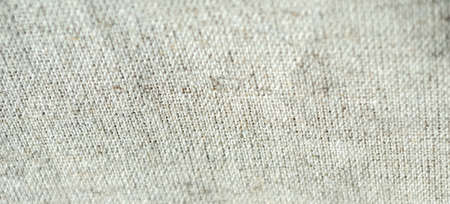 Natural rustic grey brown flax linen fabric textile sackcloth bagging canvas texture pattern background with darker border shade vignetteの写真素材