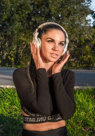 Emotional young woman listens and enjoys the music in headphonesの写真素材