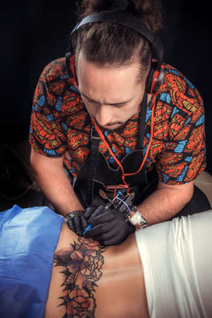 Tattoo artist designs a tattooの写真素材