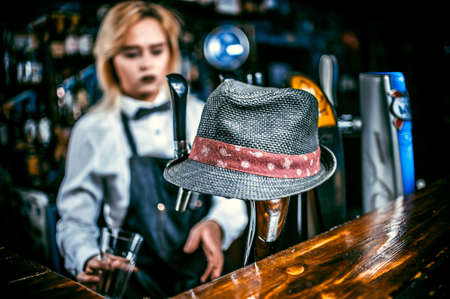 Charismatic girl bartender demonstrates his skills over the counter at barの写真素材