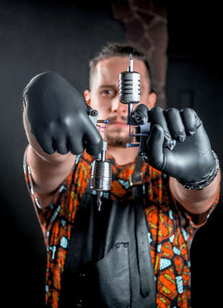 Tattoo specialist looking at the camera in tatoo salonの写真素材