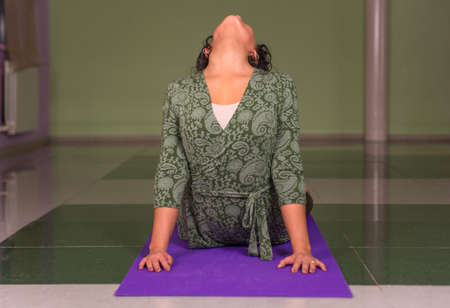 Woman performs yoga in fitness classの写真素材