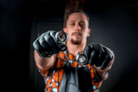 Tattooer with a tattoo-machine in tattoo studioの写真素材