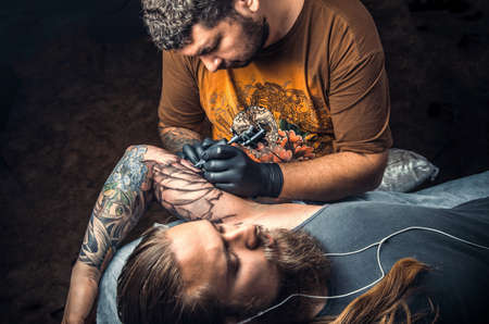 Tattoo master posing in tattoo parlorの写真素材