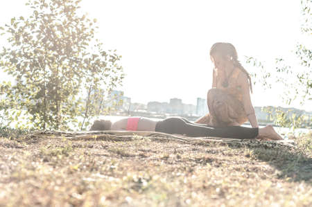 Massage expert gives her client a refreshing massage in the woods.の写真素材