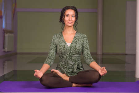 Yogi woman demonstrates yoga positions in the gymの写真素材