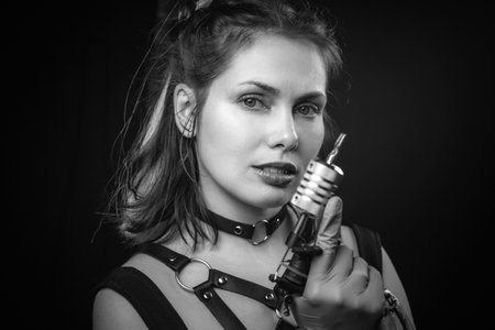 Skin master with a tattoo machine in tattoo parlorの写真素材