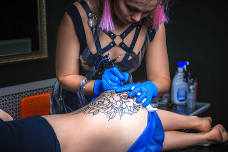 Professional tattooer create tattoo in a workshop studioの写真素材