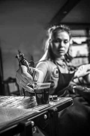Professional tattoo artist poses in a tattoo studioの写真素材
