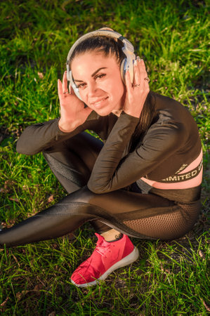 Young caucasian brunette enjoying music with headphonesの写真素材
