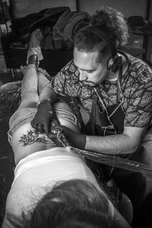 Tattoo master poses for the camera in a workshop studioの写真素材