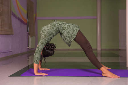 Yoga trainer stretching in yoga in fitness classの写真素材