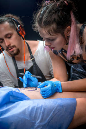 Master of the art of tattooing create tattoo in tattoo studioの写真素材