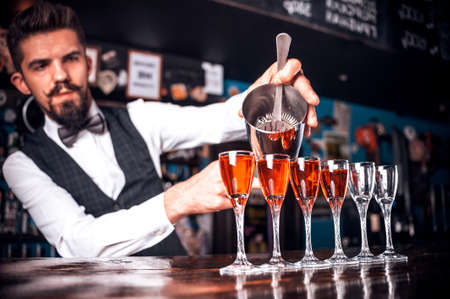 Professional barman creates a cocktail at barの写真素材