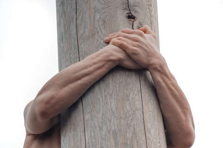 Man climbing the pole for prize during winter carnival Maslenitsa in Russiaの写真素材