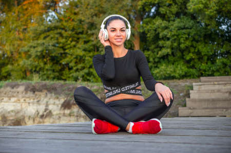 Beautiful sporty girl listens to musicの写真素材