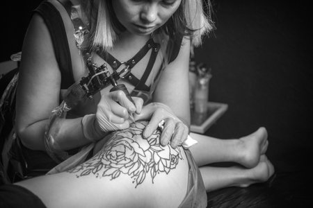 Master of the art of tattooing showing process of making a tattooの写真素材