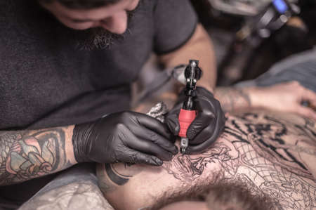 Tattooer makes tattoo in salonの写真素材