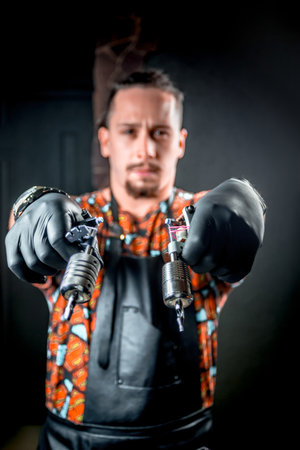 Tattoo artist poses in a workshop studioの写真素材