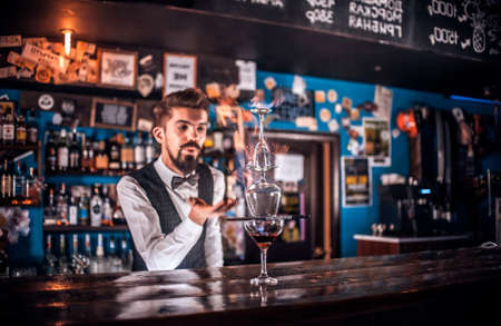 Barman concocts a cocktail at the public houseの写真素材