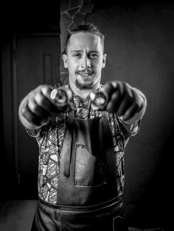 Tattooer and a tattoo machine in tattoo parlourの写真素材