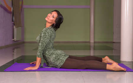 Yogi performs yoga in a studioの写真素材