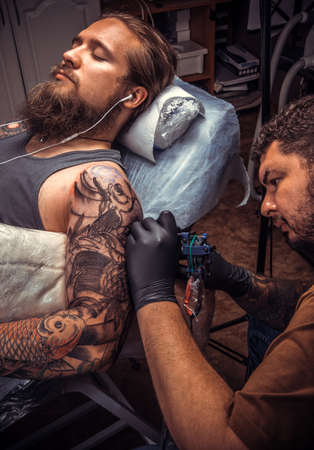 Tattoo master works in tattoo studioの写真素材