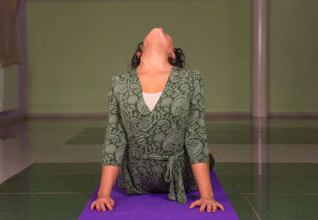 Yoga teacher works out yoga stretches in the gymの写真素材