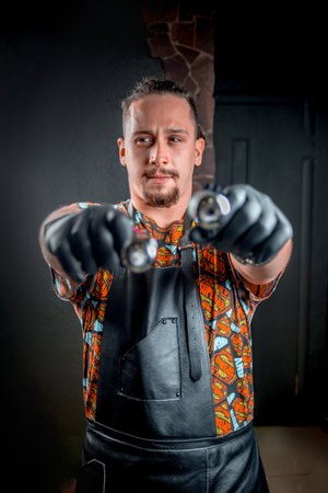 Tattoo artist with a tattoo-machine in tattoo studioの写真素材