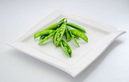 Fresh green peas isolated on a white background.の写真素材