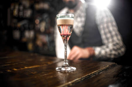 Experienced barman intensely finishes his creation at the nightclubの写真素材